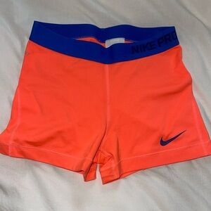 Highlighter orange Nike pro with royal blue band.